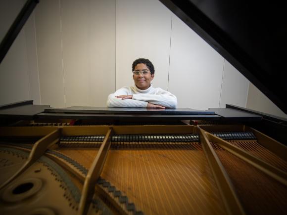 Photo of Westfield State student Aaliyah Brown seated at a piano